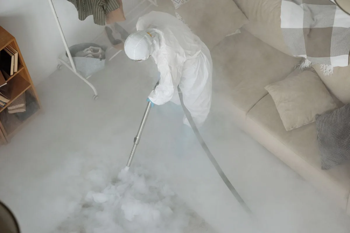 Biohazard cleanup technician in protective equipment, Ash Grove, MO